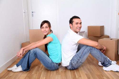 Packed boxes and removal team for a local flat move