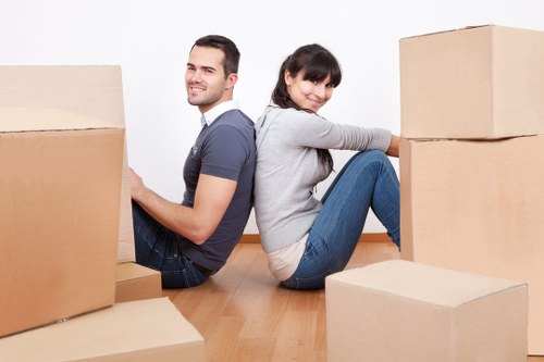 Professional movers loading boxes and furniture from a flat